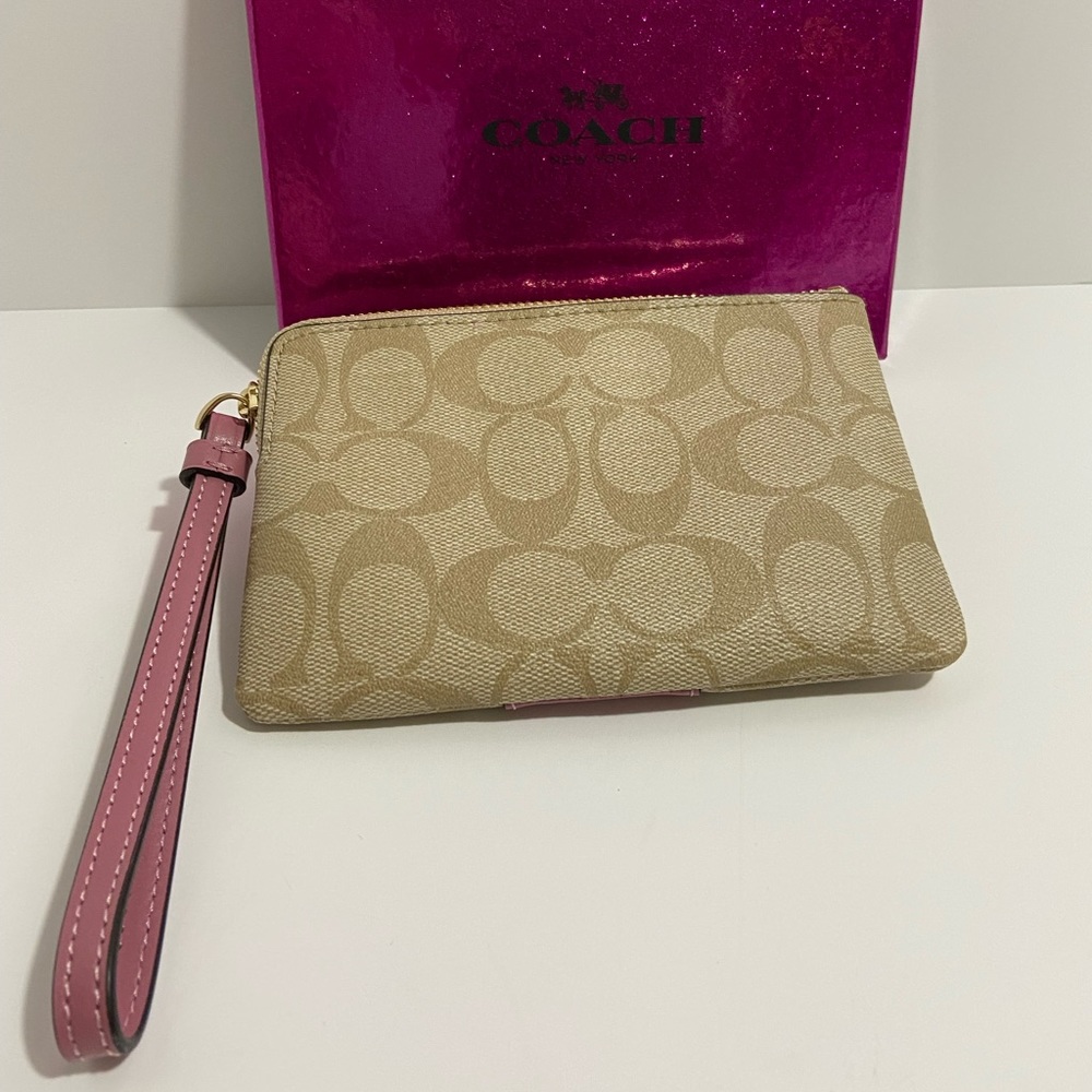 COACH WRISTLET WITH C-SIGNATURE COACH ON IT AND WITH A PINK STRIPE ON FRONT. - Picture 2 of 8